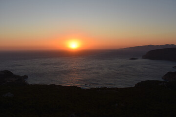 Fototapeta premium Sunset at Monolithos castle, Rhodes island, Greece. Sightseeing spots on Rhodos. View from the ruin Monolithos Castle. Holidays and travel to Rhodes Island. Rhodes seascapes and nature. 