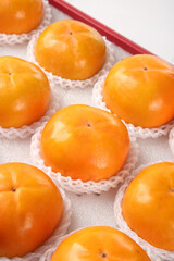 Fresh Persimmon Fruits in Protective Packaging - Premium Quality Orange Fruit Ready for Market