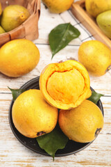 Fresh Exotic Yellow Fruit with Creamy Yolk-Colored Flesh in Rustic Kitchen Setting