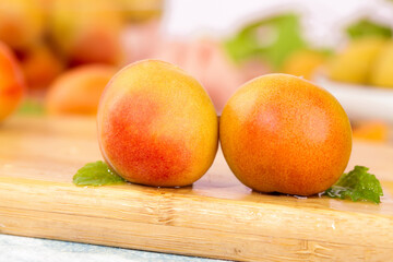 Fresh Red Orange Apricots on Wooden Board with Shallow Focus Background
