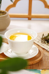 White Tea Tasting Ceremony with Porcelain Cup on Bamboo Mat - Traditional Asian Tea Culture