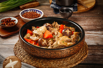 Traditional Chinese Duck Mushroom Casserole Soup in Ceramic Bowl on Wooden Table