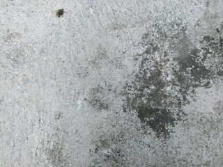Weathered Concrete Surface with Stains. Close-up of aged concrete wall with natural stains, rough surface texture, and rustic weathered details