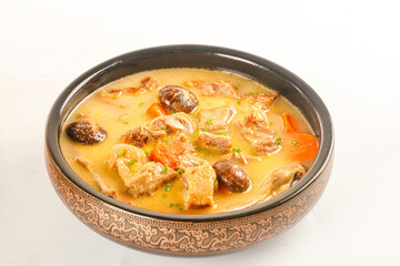 Chinese Stewed Duck Soup with Mushrooms in Traditional Ceramic Bowl