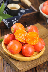 Fresh Sweet Persimmons on Wood Plate with Traditional Tea Setting