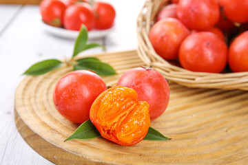 Fresh Persimmons with Honey Golden Flesh Sparkling Like Fire Crystals on Wooden Board
