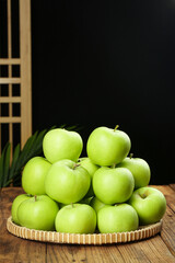 Fresh Green Shaanxi Apples in Wicker Basket on Wooden Table - Organic Tree-Ripened Fruit Display