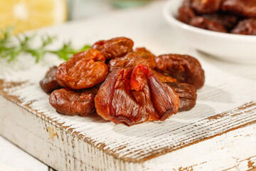 Dried Lychee Fruits from Gaozhou with Cinnamon Flavor on Wooden Board