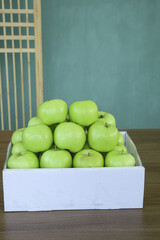 Fresh Green Shaanxi Apples in White Wooden Crate - Premium Tree-Ripened Fruit Display