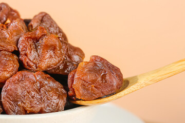 Gaozhou Dried Lychee with Cinnamon Pork - Traditional Chinese Preserved Fruit Delicacy on Wooden Spoon