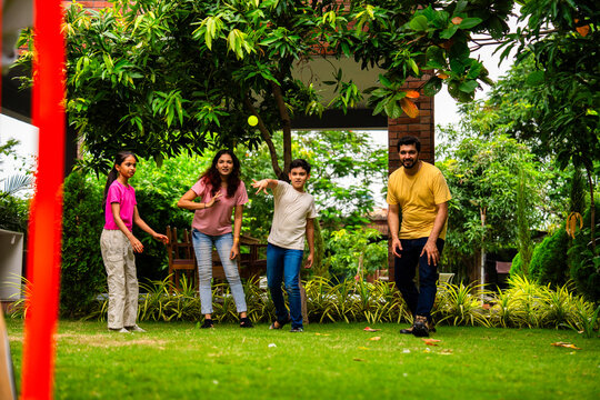 Indian family plays cricket bowling at home, enjoying weekend fun with kids in garden