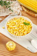 Fresh Golden Corn Kernels in White Bowl on Wooden Cutting Board - Healthy Natural Food Ingredient
