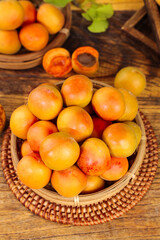 Fresh Xinjiang Apricots in Wicker Basket on Wooden Table - Organic Stone Fruit Harvest