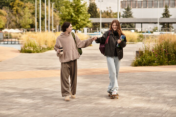 Young couple enjoying a sunny day together while skateboarding and walking in the park