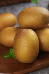 Fresh Kiwi Fruits on Wooden Board with Mint Garnish for Healthy Diet and Nutrition