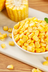 Fresh Golden Sweet Corn Kernels in Bowl with Cob on Wooden Board