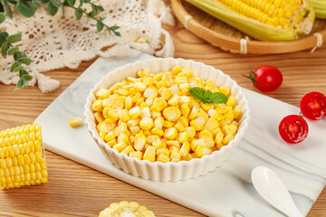 Fresh Golden Sweet Corn Kernels in Bowl with Cherry Tomatoes on Wooden Board