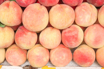 Fresh Ripe Peaches in Piles at Market Display - Summer Stone Fruit Collection