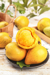 Fresh Lucuma Fruit with Creamy Golden Flesh on Rustic Wooden Table - Tropical Superfood