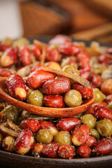 Flavored Peanuts and Mixed Nuts with Five Spice Seasoning in Wooden Spoon