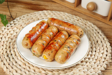 Grilled Herb Sausages on White Plate - Delicious Roasted Meat Meal on Rustic Wooden Table