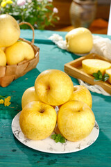 Fresh Golden Yellow Apples on Marble Plate with Rustic Basket Display