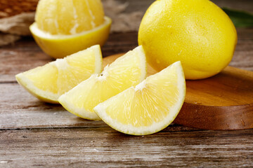 Fresh Golden Pomelo Citrus Fruit Slices on Wooden Cutting Board - Healthy Natural Food Photography