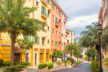 Colorful Mediterranean style buildings with palm trees lining charming street in Sunset Town, Phu Quoc island, Vietnam. Italian architecture in Asia. Travel and touristic destination in Asia