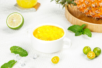 Tropical Pineapple Smoothie Bowl with Fresh Citrus and Mint on White Marble Background