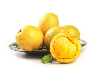 Fresh Yellow Egg Fruit Canistel with Creamy Flesh on Black Plate