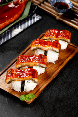 Grilled Eel Sushi Roll with Teriyaki Glaze on Wooden Serving Board - Japanese Cuisine