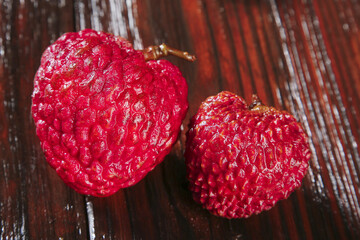 Fresh Red Lychee Fruits on Wooden Background - Exotic Tropical Asian Produce
