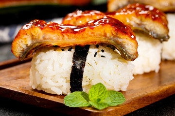Grilled Eel Sushi with Sweet Sauce on Wooden Board - Traditional Japanese Unagi Nigiri Cuisine