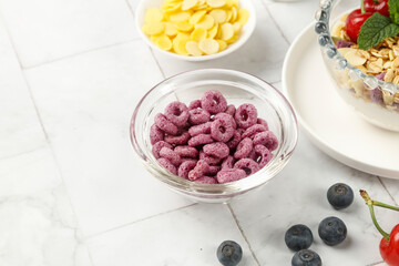 Healthy Breakfast Cereal Bowl with Fresh Berries and Oats on White Marble Background