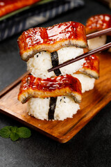 Japanese Unagi Kabayaki Eel Sushi with Teriyaki Glaze on Wooden Plate
