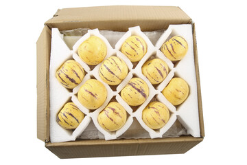 Yellow Striped Melons in Shipping Box with Protective Packaging for Fresh Fruit Distribution