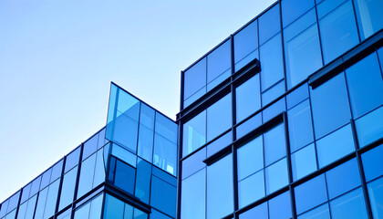 Low-angle view of corporate skyscraper architecture in blue tones.