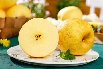 Fresh Yellow Fuji Apples Sliced on Marble Plate with Mint Garnish - Healthy Organic Fruit Display