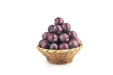 Obraz premium Fresh Delicious Plums in Wicker Basket on White Background