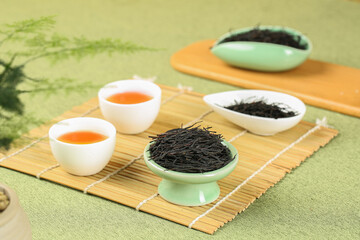 Traditional Chinese Tea Ceremony with Loose Tea Leaves and Ceramic Teaware on Bamboo Mat