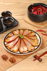 Traditional Chinese Smoked Pork Bacon Slices with Spices and Tea on Wooden Table