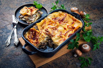 Artisan homemade traditional vincisgrassi marche pasta with mushrooms, prosciutto and bechamel cream over baked in casserole