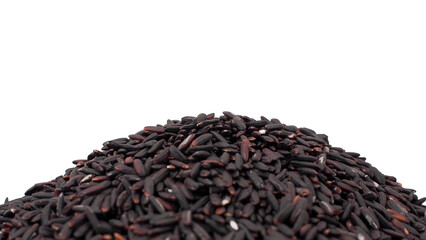 Close-up of black rice heap isolated on white background, organic whole grain, healthy superfood, and natural ingredient.