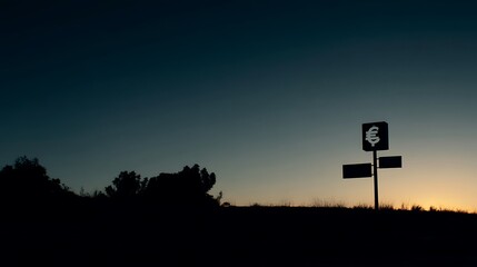 A solitary road sign stands against the backdrop of a tranquil sunset, casting a silhouette against the darkening sky.
