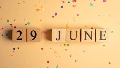 Wooden Blocks with Date 29 June. Calendar for birthday or anniversary on solid colored background with confetti