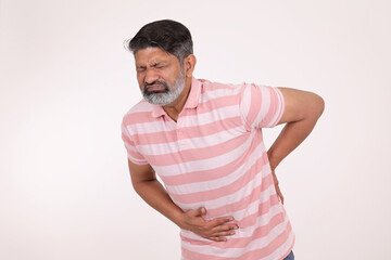 Fototapeta premium Portrait of a indian man having stomach pain on white