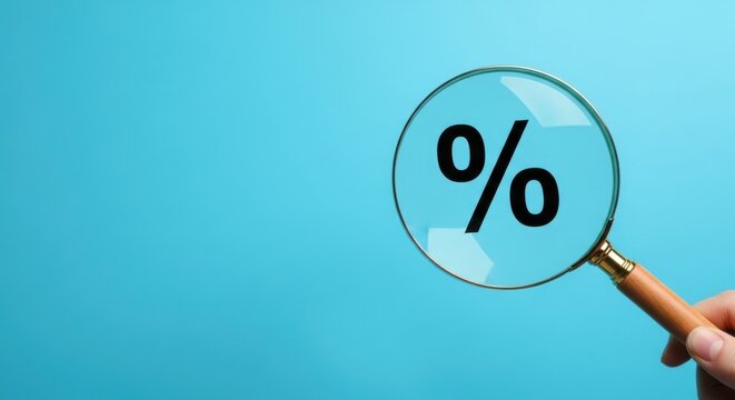 Magnifying glass focusing on a percentage symbol on a light blue background.