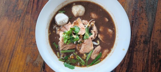 Pork waterfall noodles on a wooden table