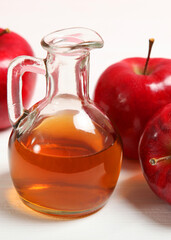 apples and apple cider vinegar on the table.. Vertical photo format