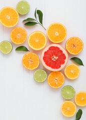 Different citrus and juicy slices on a colored background. Place to insert text.. Vertical photo format